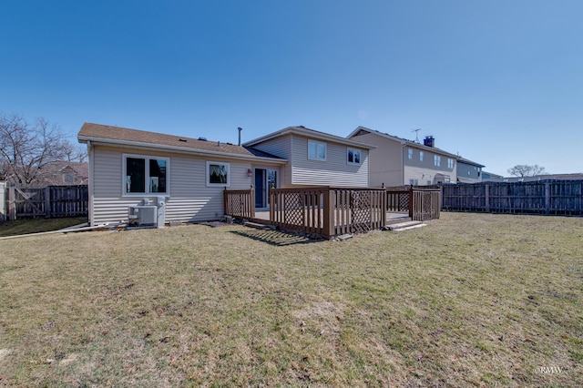 rear view of house featuring cooling unit, a lawn, a fenced backyard, and a wooden deck