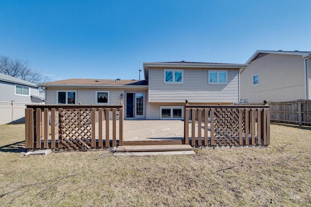 back of property featuring a fenced backyard, a wooden deck, and a yard