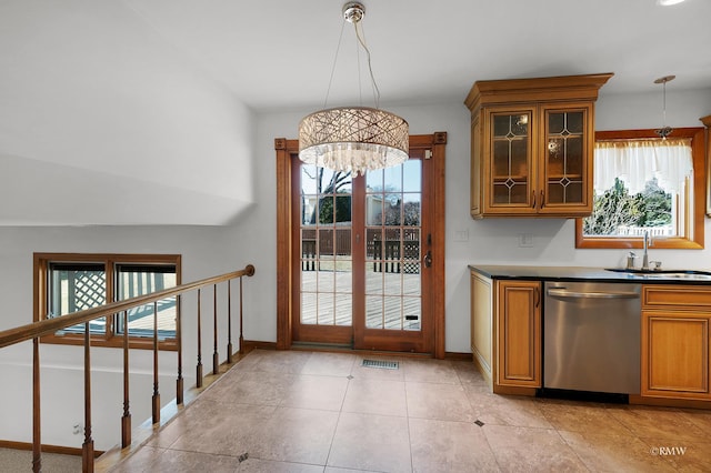 kitchen with visible vents, glass insert cabinets, dishwasher, brown cabinetry, and a sink