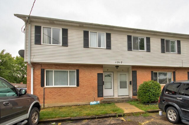 townhome / multi-family property featuring brick siding
