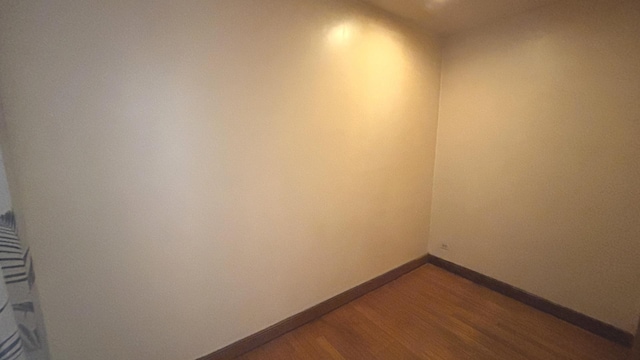 unfurnished room featuring dark wood-style floors and baseboards