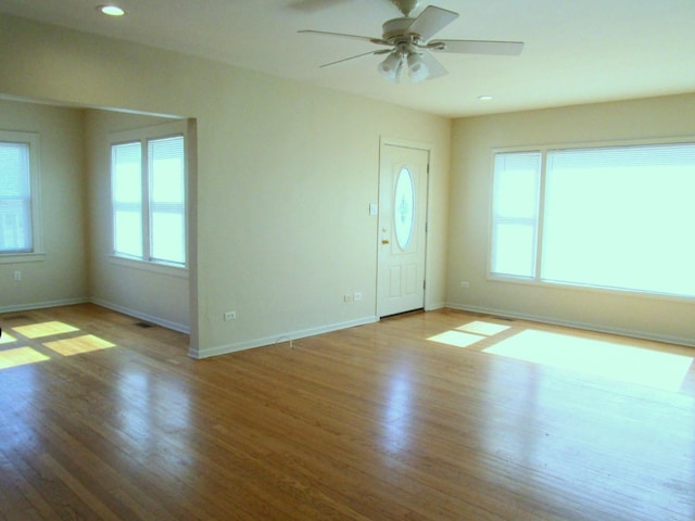 interior space featuring recessed lighting, baseboards, and wood finished floors