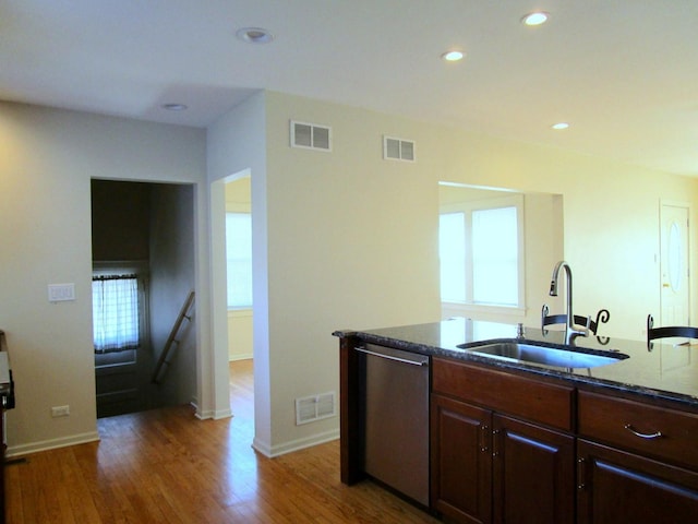 kitchen featuring a sink, visible vents, and dishwasher