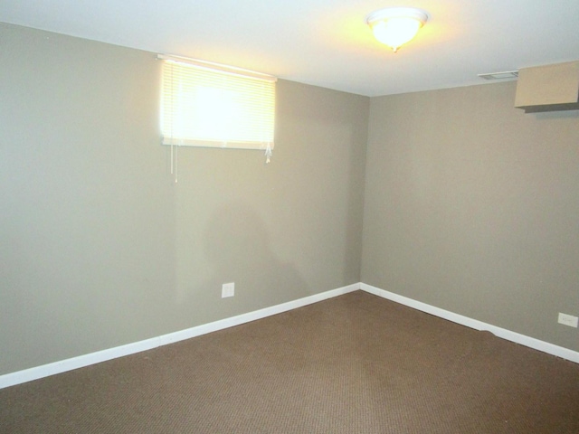 below grade area featuring carpet, baseboards, and visible vents