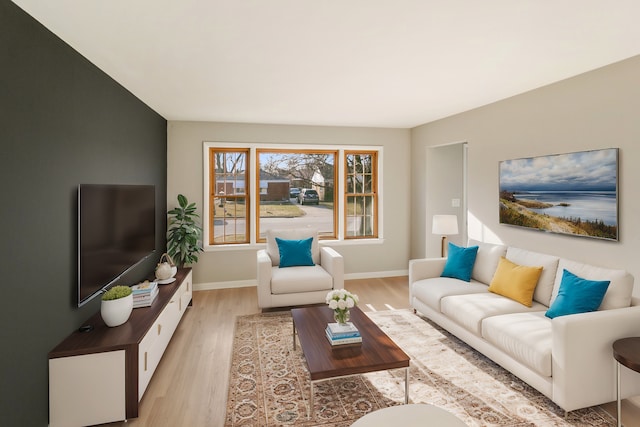 living room featuring baseboards and light wood finished floors