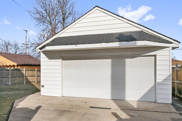 detached garage featuring fence