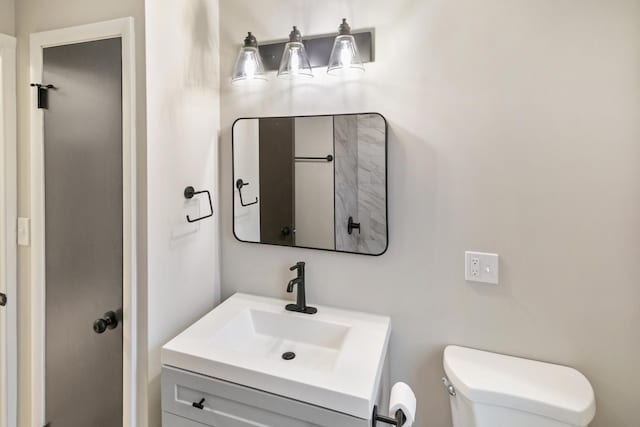 bathroom with toilet and vanity