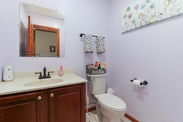 half bath featuring toilet and vanity