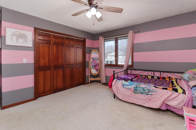 bedroom with a closet, light colored carpet, and ceiling fan