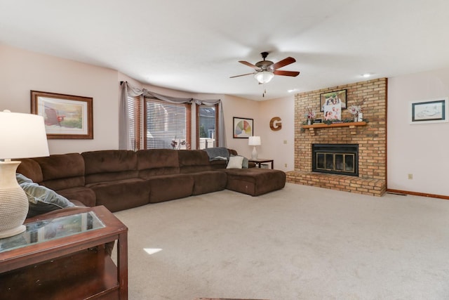 living room featuring a brick fireplace, baseboards, carpet, and ceiling fan