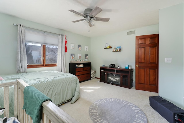 bedroom with visible vents, a ceiling fan, and carpet floors