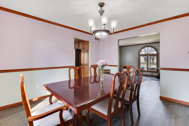 dining room with an inviting chandelier, baseboards, light wood finished floors, and ornamental molding