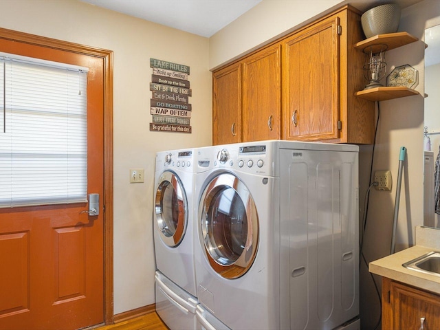 laundry area with cabinet space and washing machine and dryer