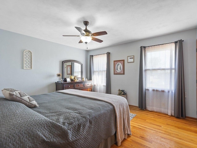 bedroom featuring light wood finished floors and ceiling fan