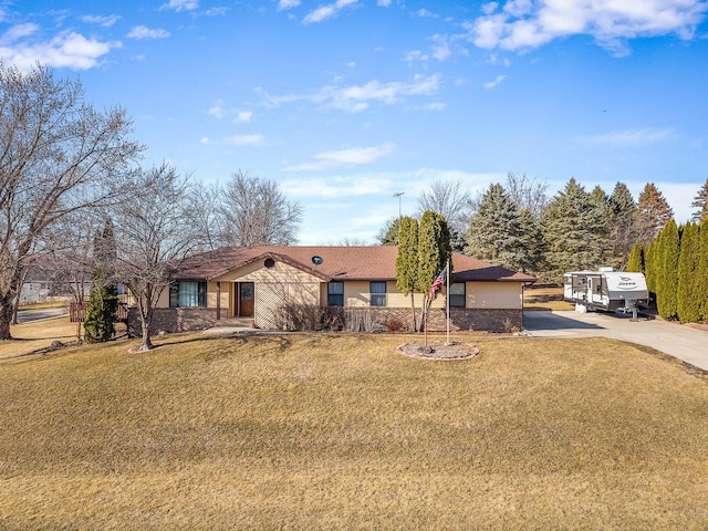 ranch-style home with concrete driveway and a front yard