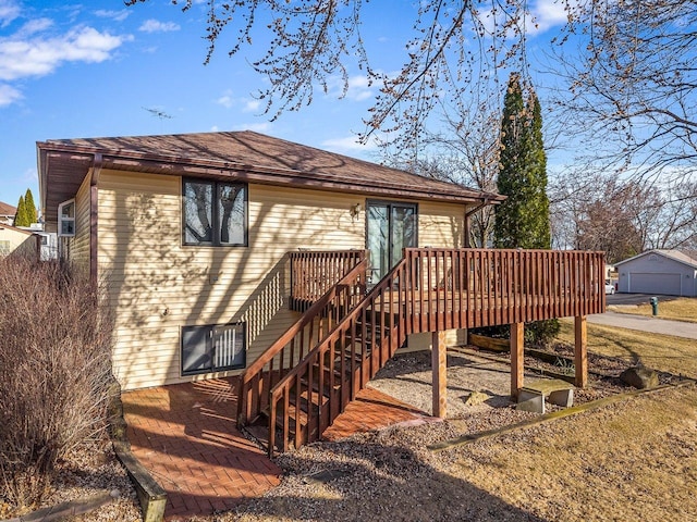 rear view of property featuring a deck and stairs