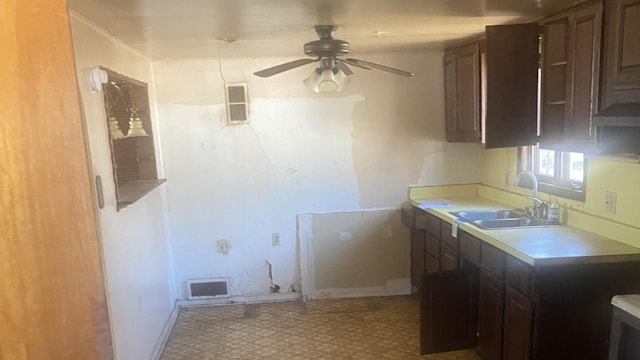 kitchen featuring tile patterned floors, visible vents, a sink, light countertops, and ceiling fan