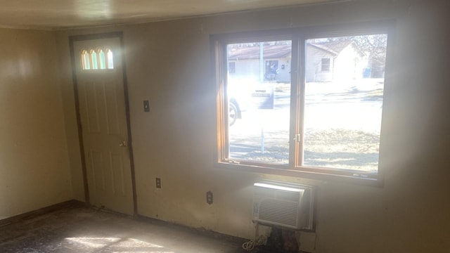 unfurnished room featuring a wealth of natural light and a wall mounted AC