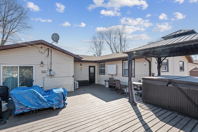 deck featuring a gazebo and a hot tub