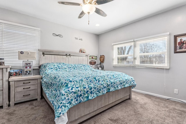 carpeted bedroom featuring ceiling fan and baseboards