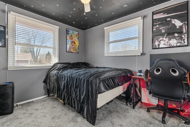 bedroom featuring multiple windows, carpet, and baseboards