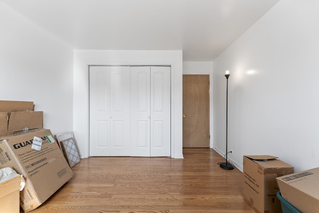 bedroom with a closet and light wood-type flooring