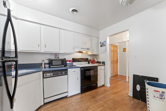 kitchen with stainless steel microwave, under cabinet range hood, dishwasher, electric range oven, and white cabinetry