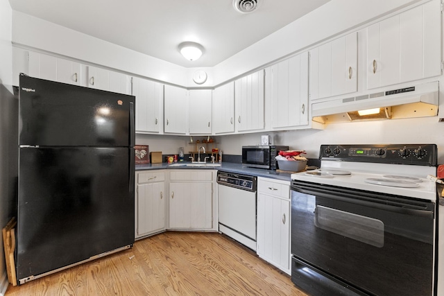 kitchen featuring freestanding refrigerator, electric range oven, under cabinet range hood, dishwasher, and stainless steel microwave