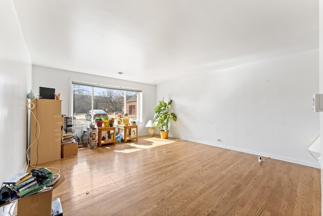 interior space featuring wood finished floors and baseboards