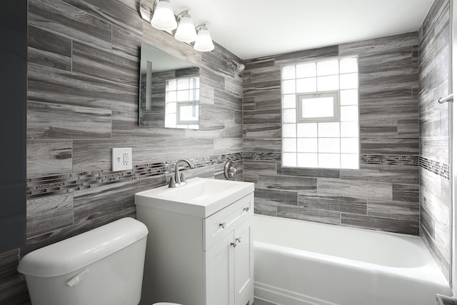 full bathroom with vanity,  shower combination, toilet, and a wealth of natural light