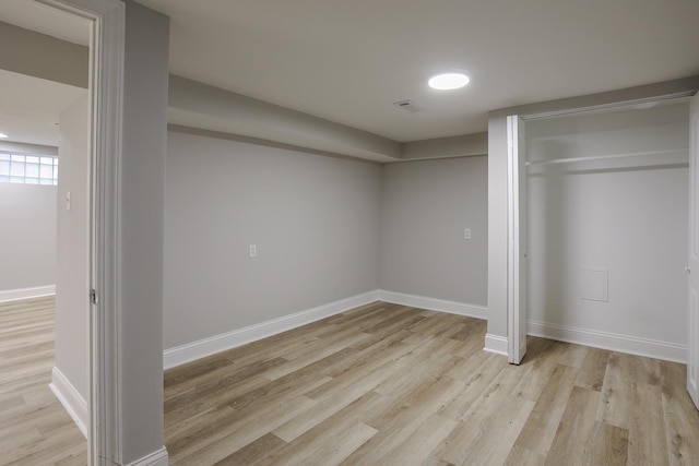 unfurnished bedroom featuring light wood-style flooring, visible vents, baseboards, and a closet