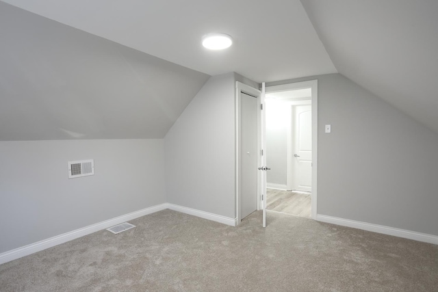 bonus room with visible vents, carpet flooring, lofted ceiling, and baseboards