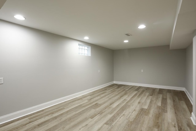 below grade area featuring visible vents, recessed lighting, light wood-type flooring, and baseboards