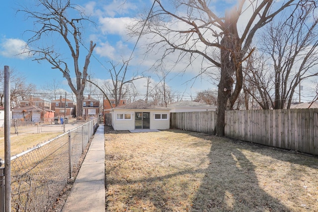 view of front of house with a residential view, a front yard, and a fenced backyard