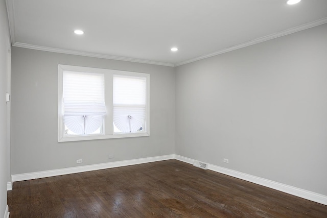 unfurnished room featuring visible vents, baseboards, dark wood finished floors, and ornamental molding