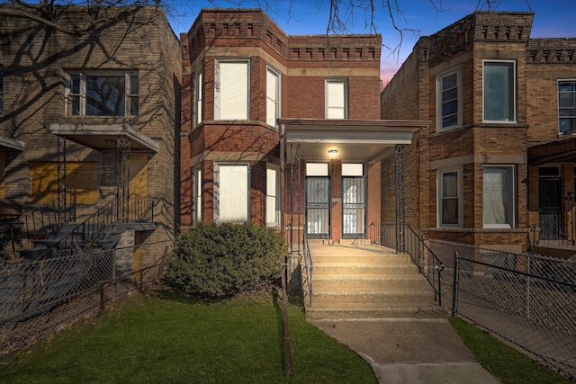 view of front of house with brick siding, covered porch, and fence