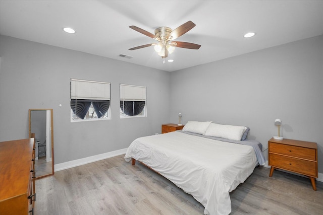 bedroom with light wood-style flooring, recessed lighting, baseboards, and visible vents