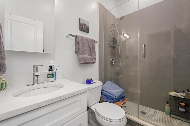 bathroom with vanity, toilet, and a stall shower