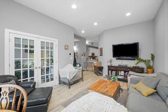 living room with recessed lighting, french doors, and light wood-style floors