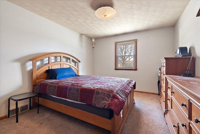 bedroom with visible vents, light colored carpet, and baseboards