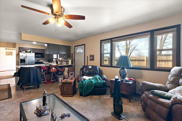 living area with ceiling fan and carpet flooring