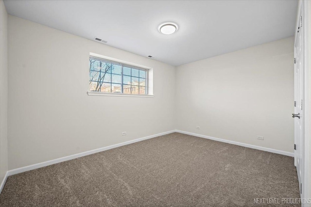 empty room featuring visible vents, baseboards, and carpet