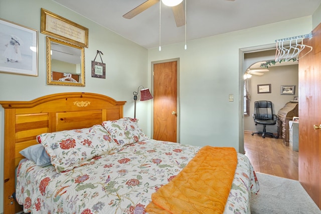 bedroom with a ceiling fan and wood finished floors