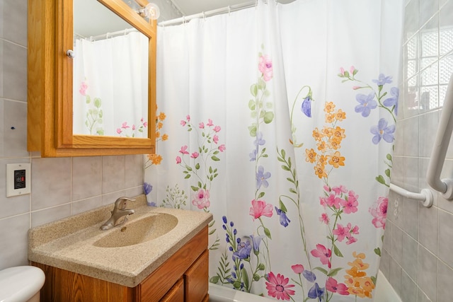 bathroom with toilet, tasteful backsplash, a shower with shower curtain, tile walls, and vanity