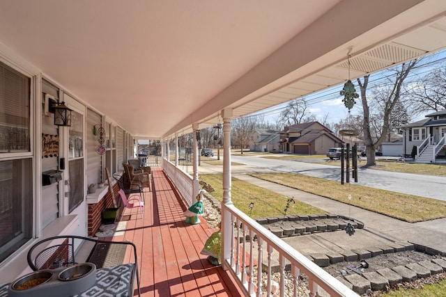 deck with a residential view and a porch