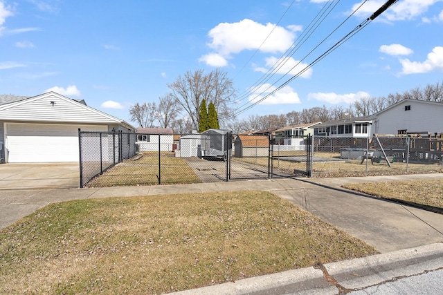 view of yard with a fenced front yard and a gate