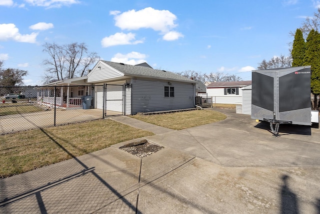 view of property exterior with a gate, a yard, and fence