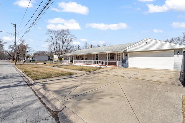 single story home with a garage, a porch, and driveway