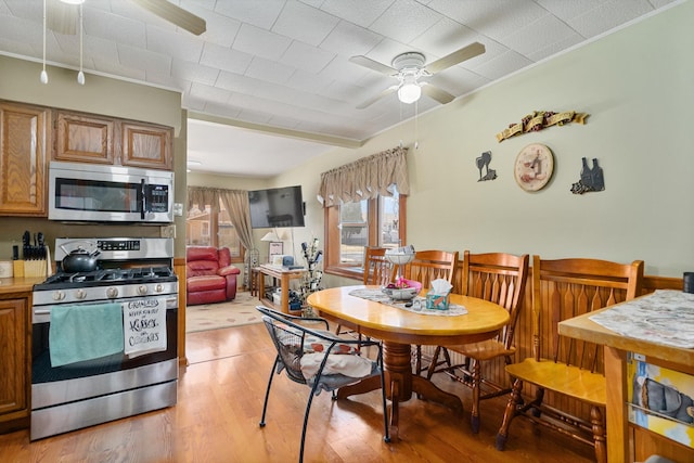 dining room featuring light wood finished floors and ceiling fan