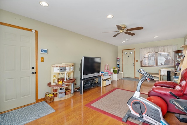 living room featuring a ceiling fan, recessed lighting, wood finished floors, and baseboards